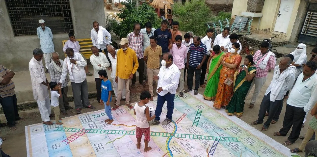  Farmers enjoying a game of snakes and ladders. 
